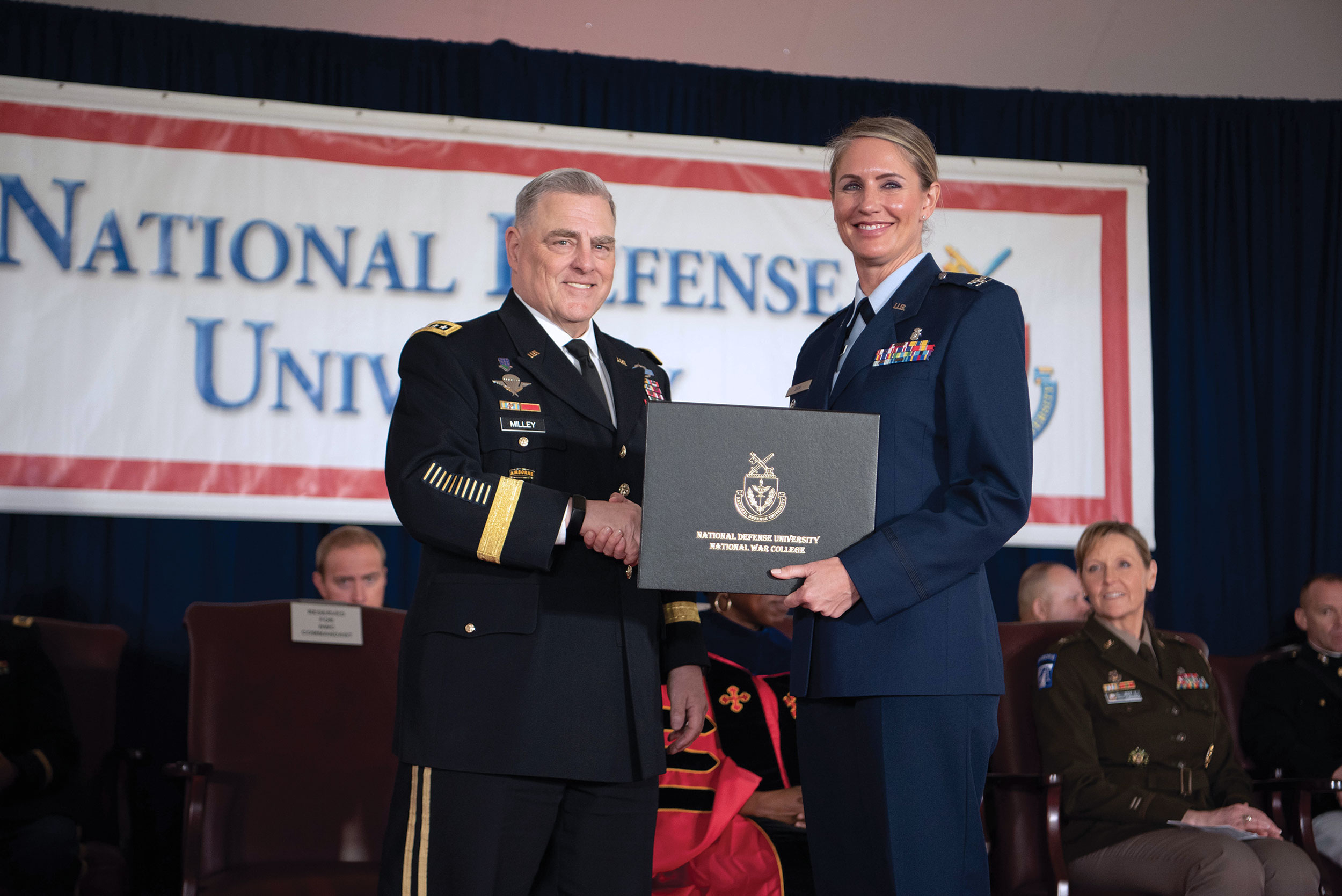 Then Chairman of the Joint Chiefs of Staff General Mark A. Milley congratulates National War College graduate during National Defense University’s 2023 graduation ceremony